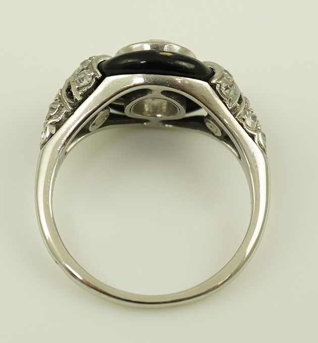 An Art Deco platinum black enamel and diamond set ring